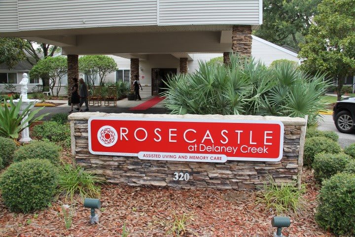 Entrance sign for Rosecastle of Delaney Creek with surrounding landscaping.