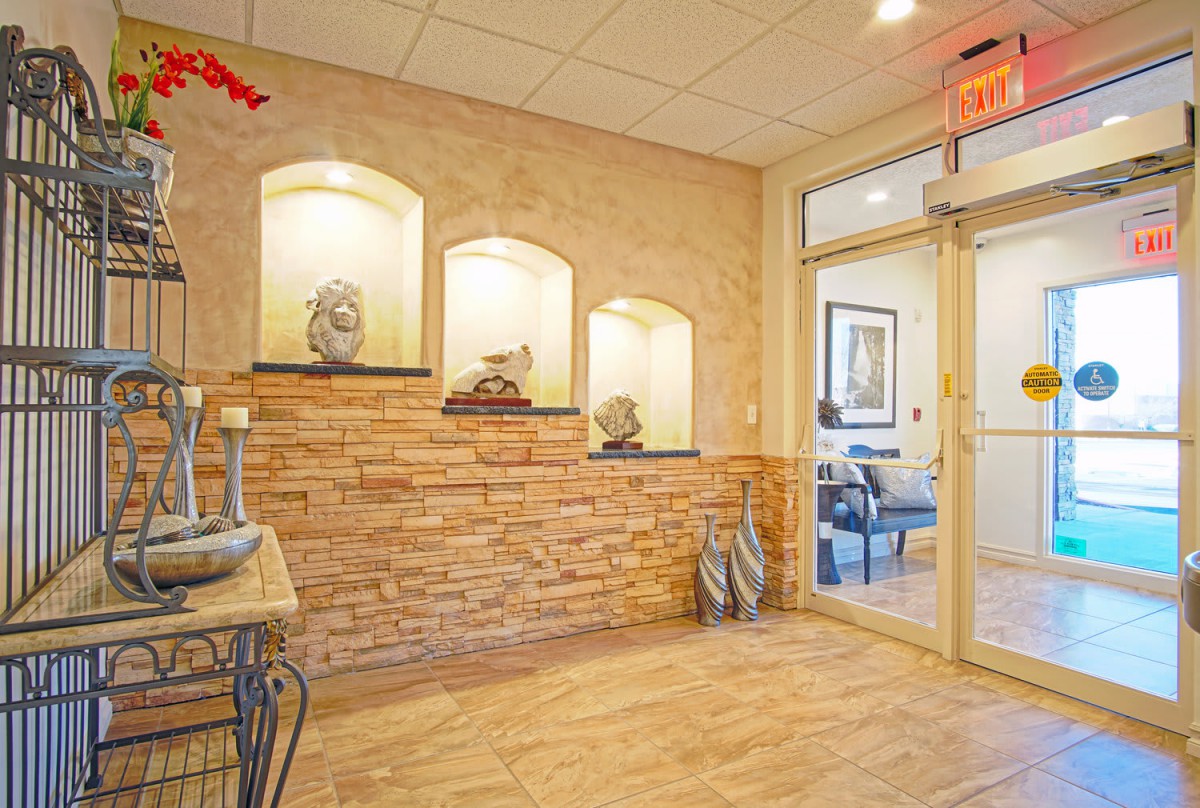 A welcoming office lobby with decorative stone walls and elegant lighting.