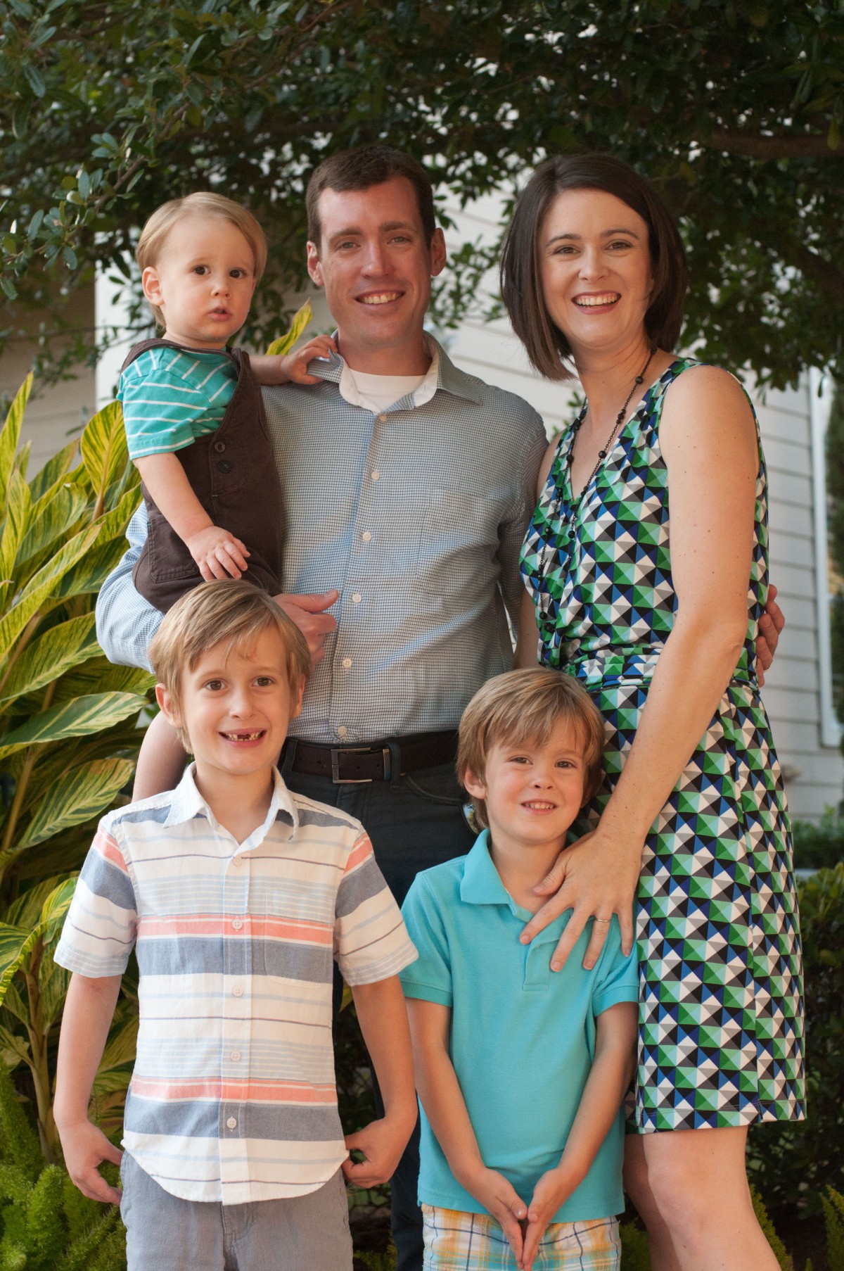 A happy family posing for a photo outdoors.