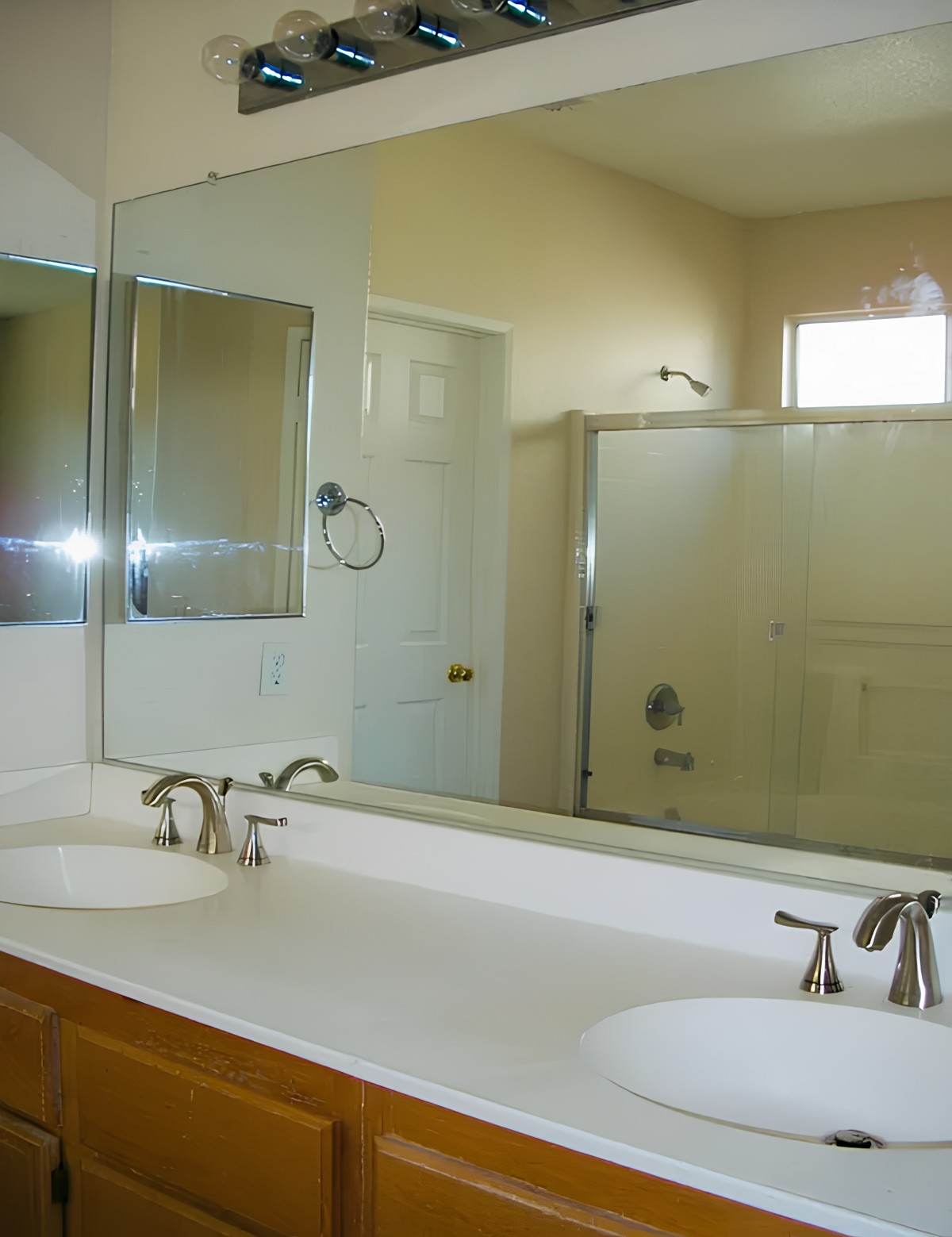A clean bathroom with a double sink vanity and a shower.