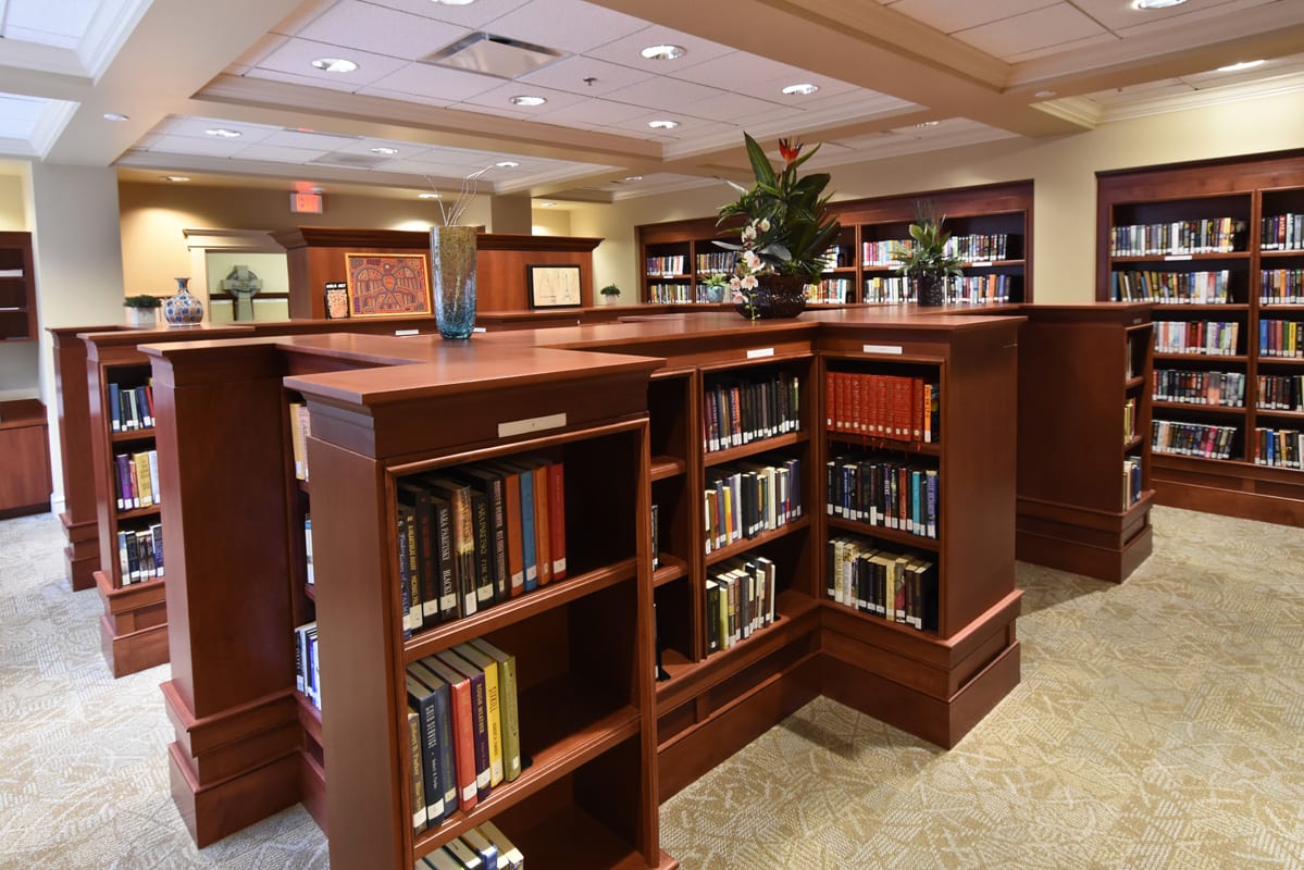 A cozy library interior with wooden bookshelves filled with books.