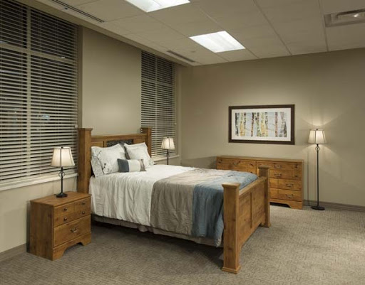 A stylish modern bedroom featuring a wooden bed frame, matching nightstands, and ambient lighting.