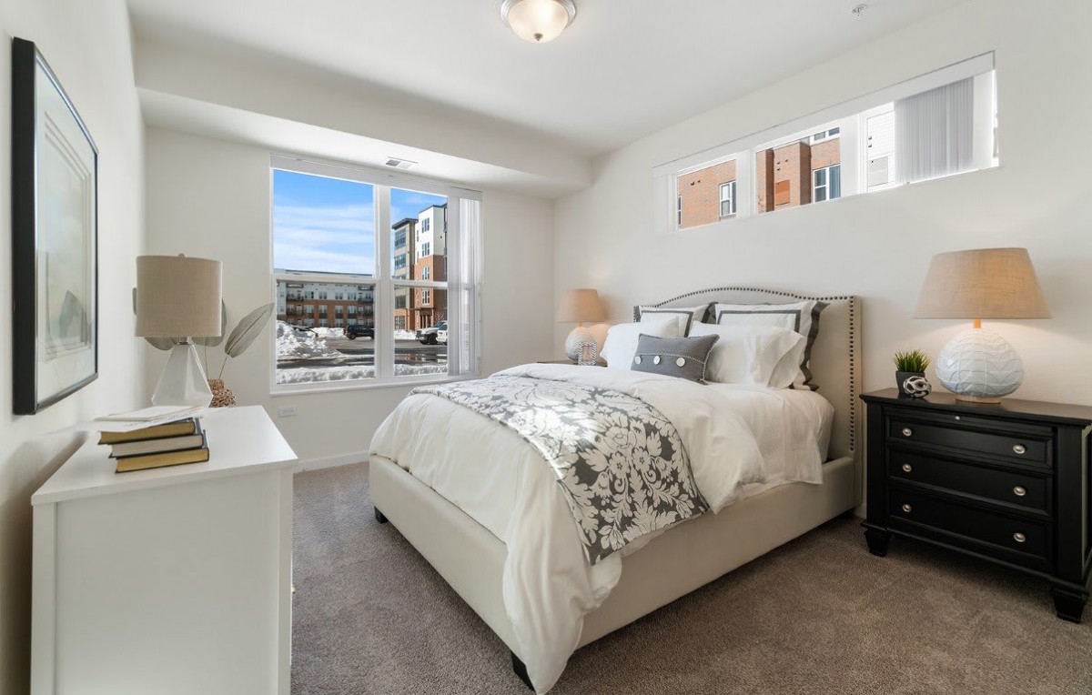 A cozy bedroom with natural lighting and stylish decor.