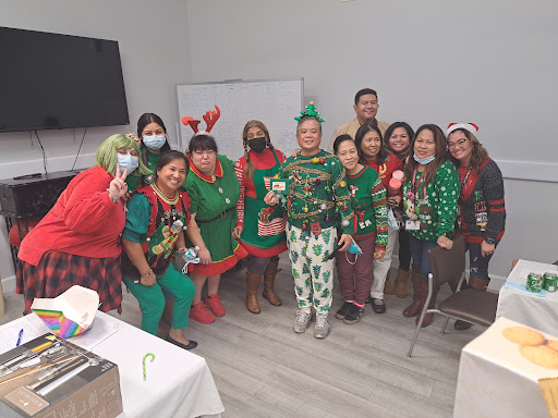 A joyful gathering of colleagues celebrating the Christmas spirit with festive outfits.