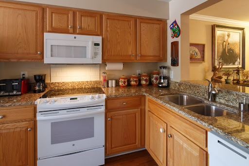 A cozy kitchen featuring modern appliances and warm wooden cabinetry.