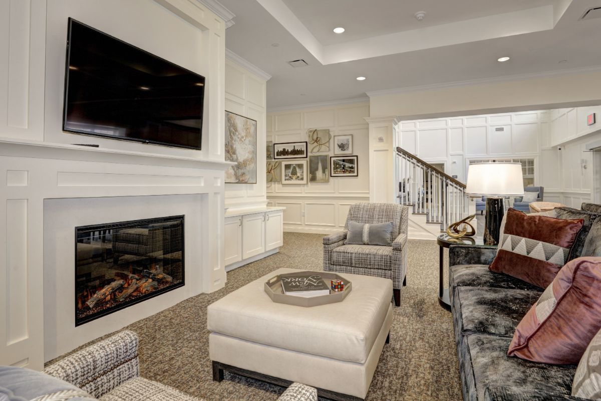 A modern living room with a fireplace, television, and stylish furniture.
