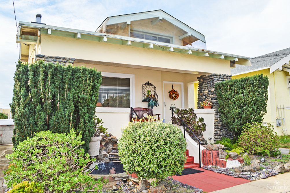 A charming house with a well-maintained front yard and porch.