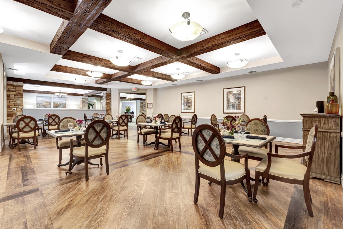 A modern dining room with wooden floors and stylish furniture.