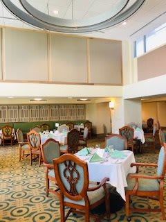 An elegant indoor dining area with neatly arranged tables and chairs.