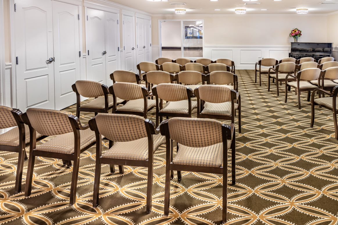 Empty conference room with chairs arranged in rows.