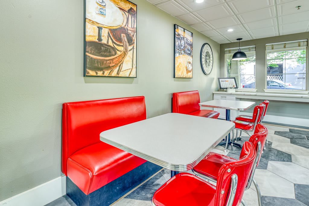 A cozy diner interior featuring red booths and contemporary decor.