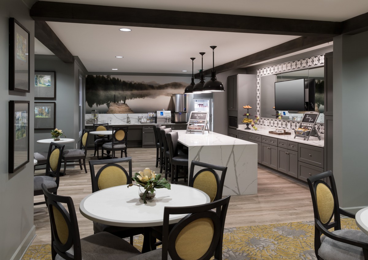 A modern kitchen and dining area with stylish tables, chairs, and contemporary decor.