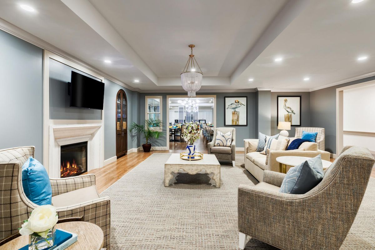 A well-designed living room featuring comfortable furniture, elegant decor, and a cozy fireplace.