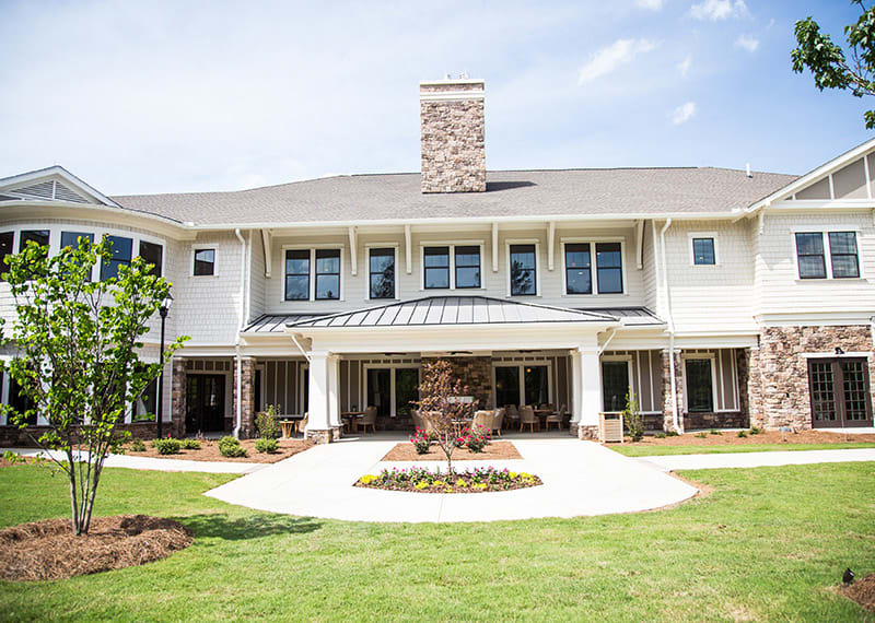 A luxurious two-story house with a well-maintained front yard.