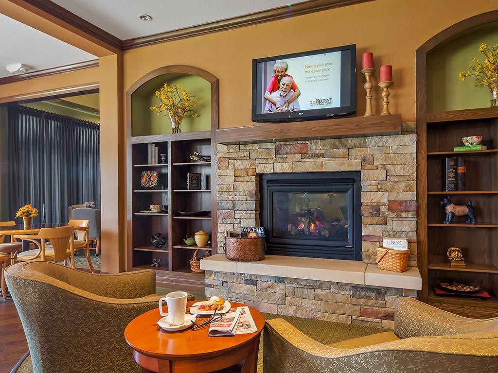 A cozy living room with a fireplace, television, and comfortable seating.