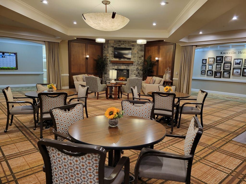 A cozy living room with multiple seating areas, a fireplace, and elegant decor.