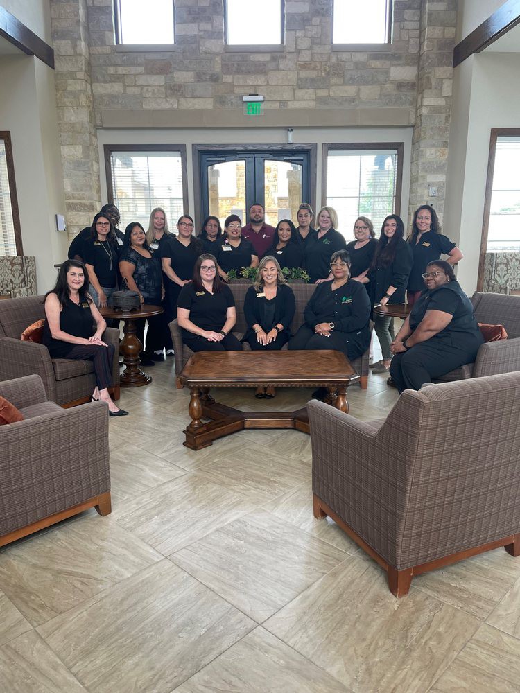 A group of people posing together in an office setting.