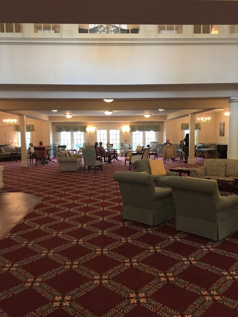A spacious lounge area with comfortable seating and elegant carpeting.