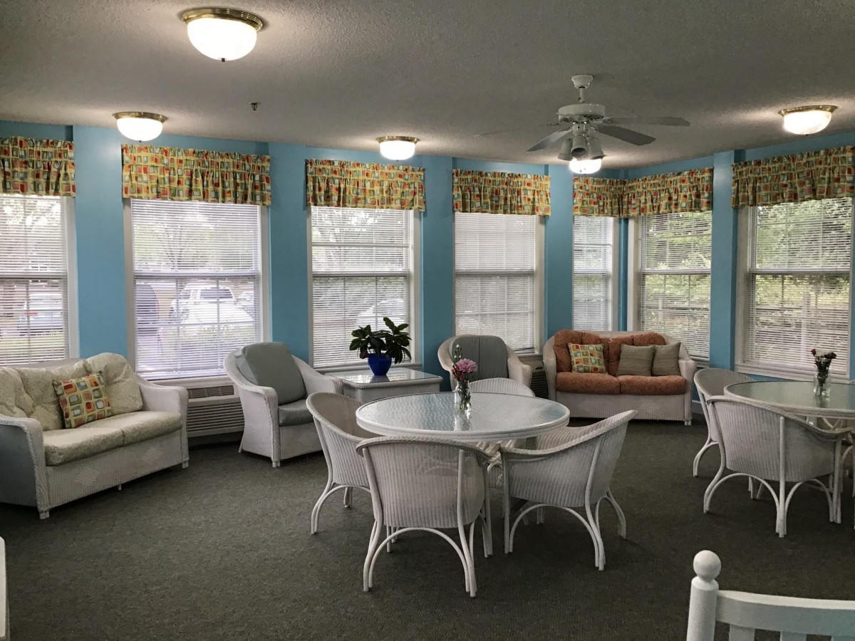 A cozy living room with comfortable seating and large windows.