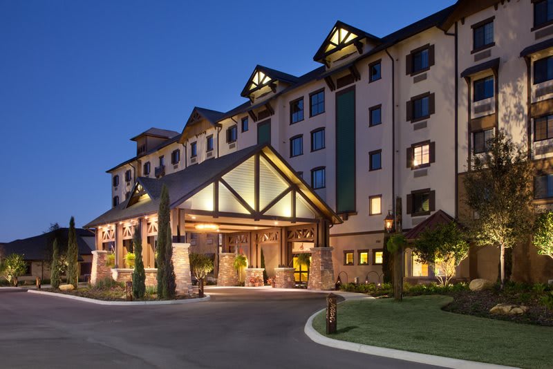 A well-lit hotel exterior with an inviting entrance during nighttime.