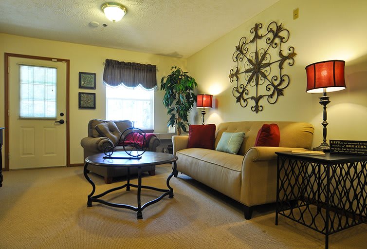 A cozy living room with stylish decor, featuring a comfortable sofa, a coffee table, and decorative wall art.