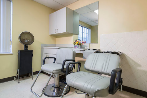 A tidy and modern hair salon interior with seating and a welcoming atmosphere.