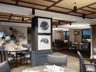 A modern restaurant interior featuring elegant dining setups and artistic decor.