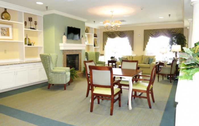 A cozy living room with comfortable seating, a fireplace, and a television.