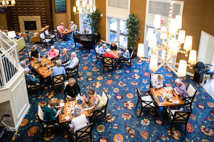 A bustling restaurant dining area with people enjoying their meals.