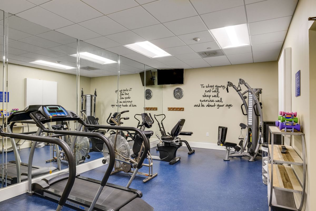 An indoor gym with various fitness equipment and exercise machines.