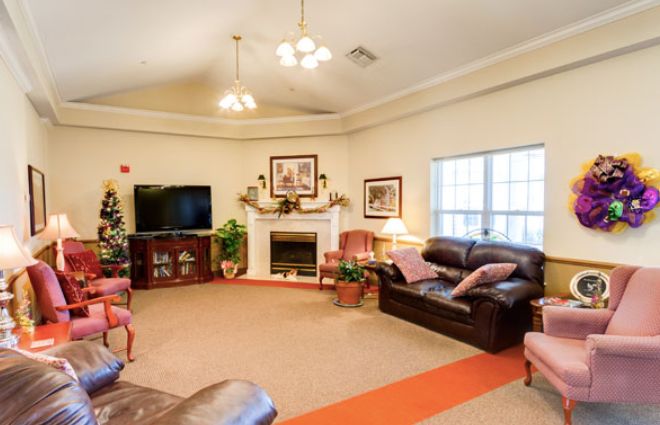 A cozy living room with sofas, a fireplace, and a television.