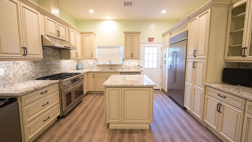 A modern kitchen featuring elegant cabinetry, a central island, and bright lighting.