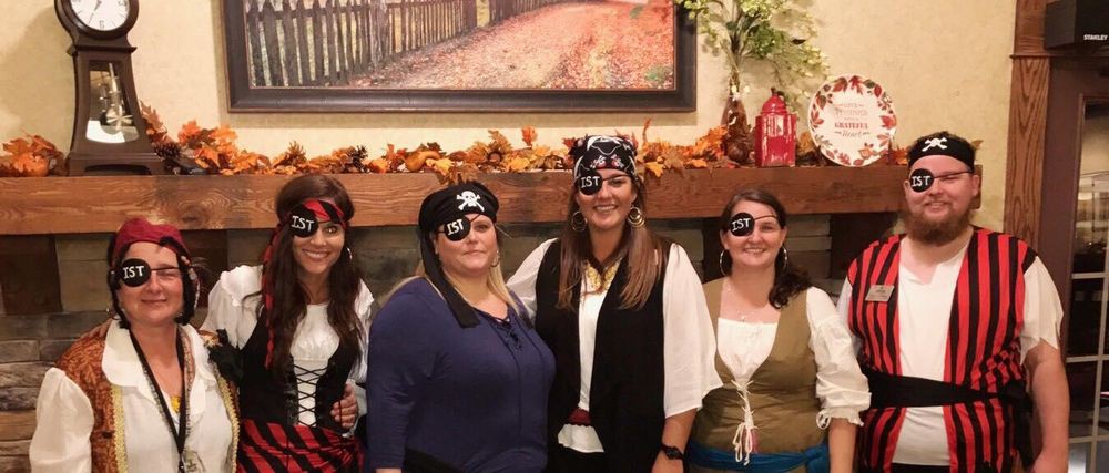 A group of people dressed in pirate costumes for a Halloween celebration.