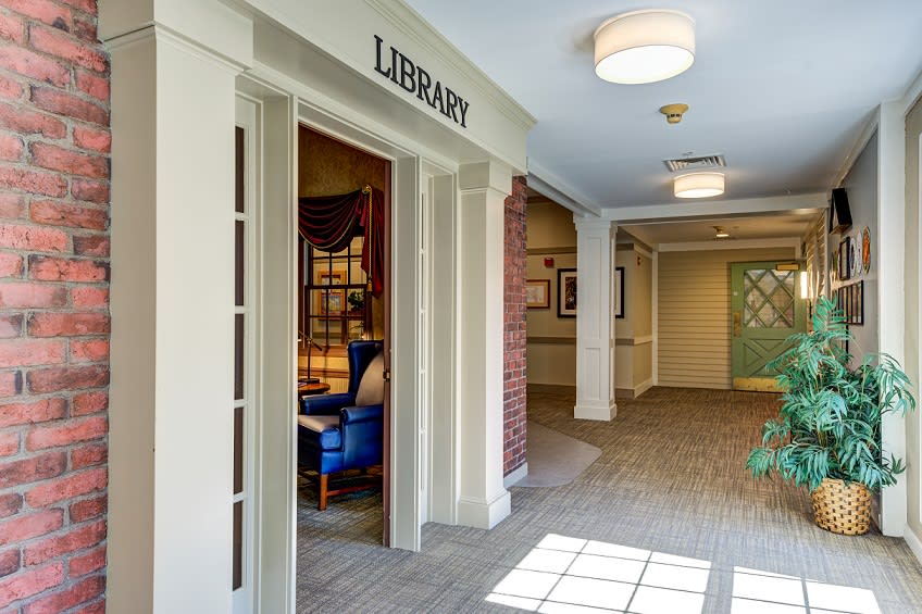 Entrance to a library with a cozy reading area visible inside.