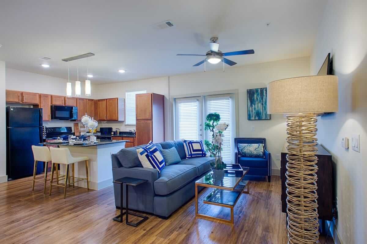 A modern open-plan living room and kitchen with stylish furnishings and decor.
