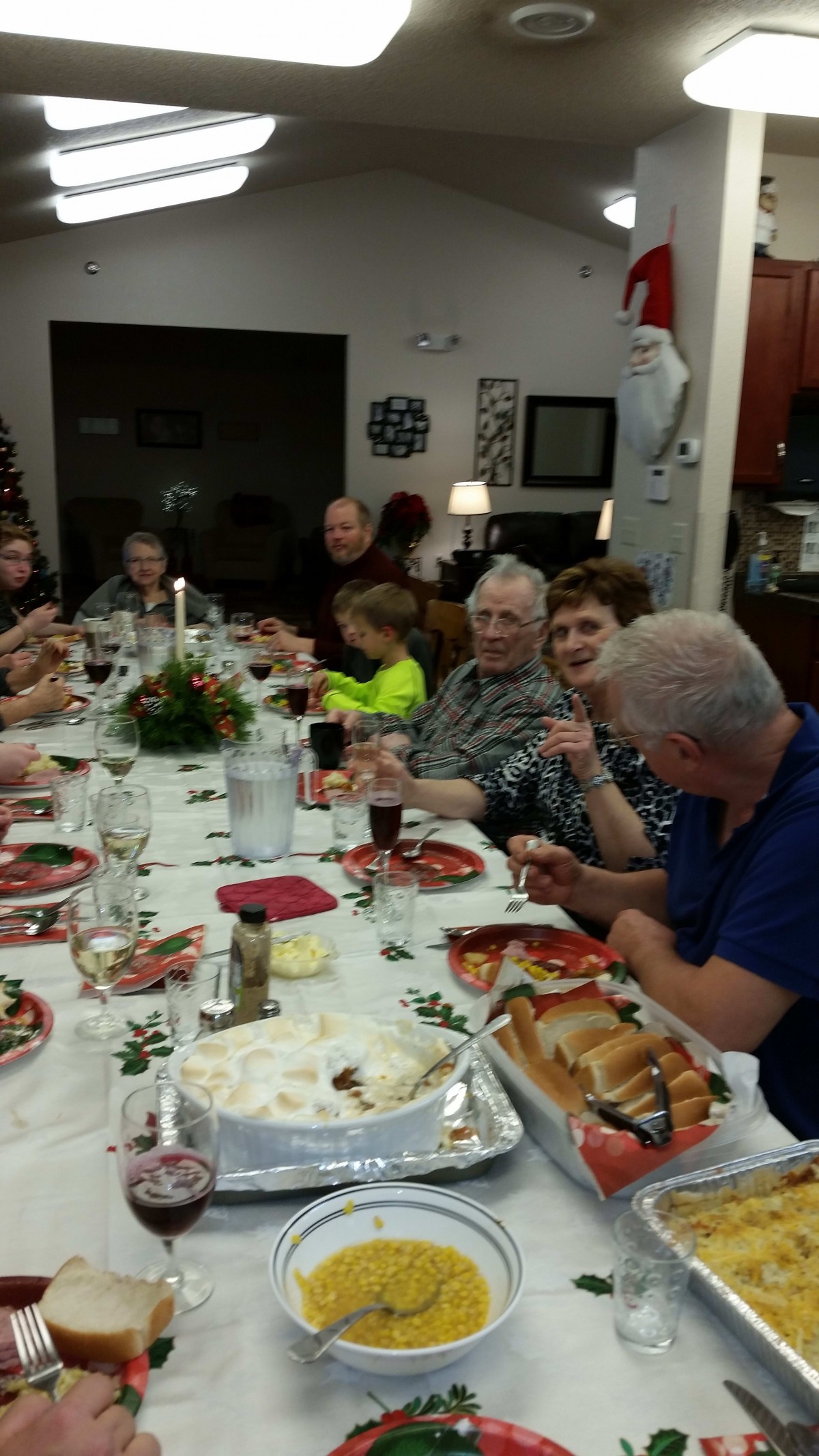 A family gathering around a dinner table celebrating together.