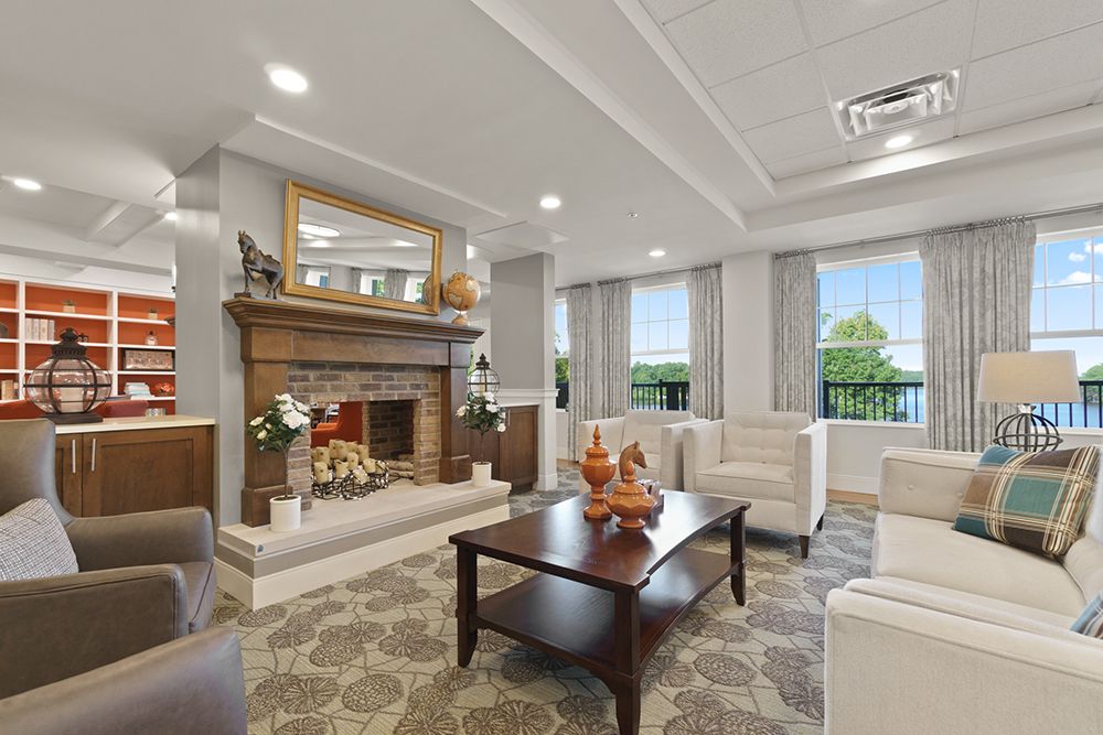 A stylish living room with a cozy fireplace, comfortable sofas, and a decorative coffee table.