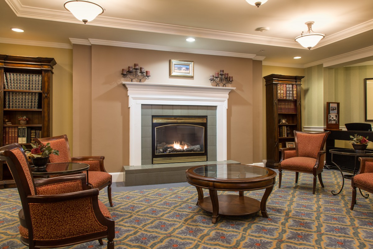 A cozy living room with a fireplace and comfortable seating.