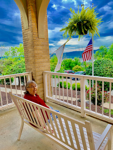 A peaceful moment on the porch with a beautiful view and gentle clouds overhead.