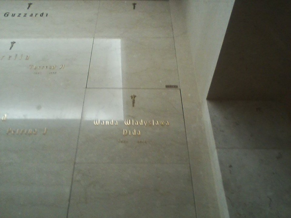 A tiled floor with a reflection of light in the corner of a room.