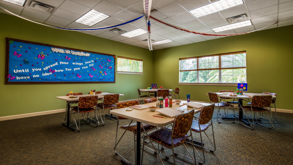 A decorated classroom setup with tables and chairs ready for students.