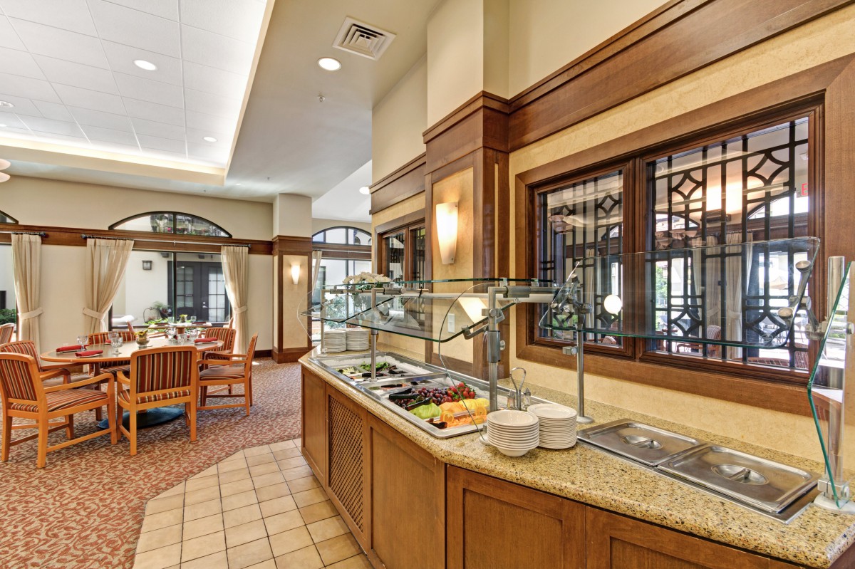 A restaurant buffet setup with a salad bar and elegant interior design.