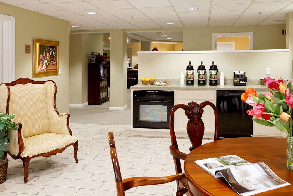 A cozy kitchen and dining area featuring classic furniture and a coffee station.