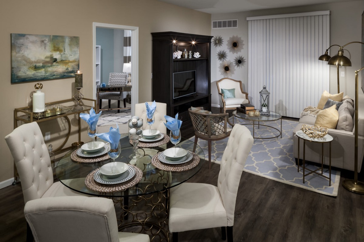 A modern open-plan living and dining area featuring elegant furniture and a stylish table setting.