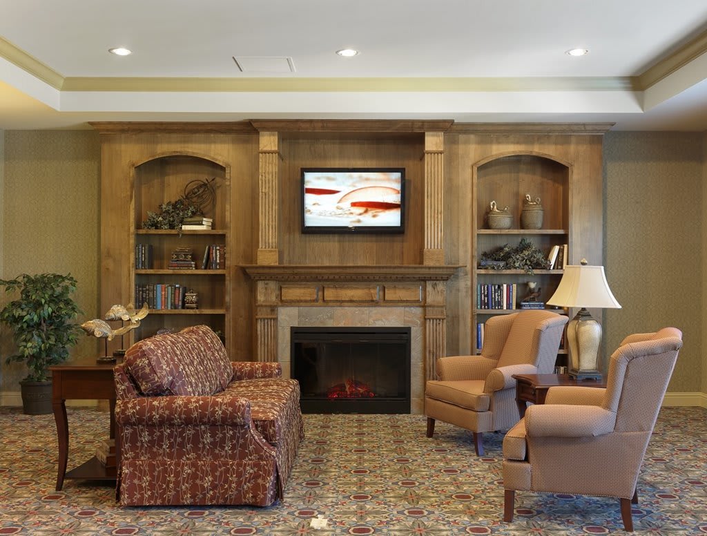 A cozy living room with a fireplace, television, and comfortable seating.