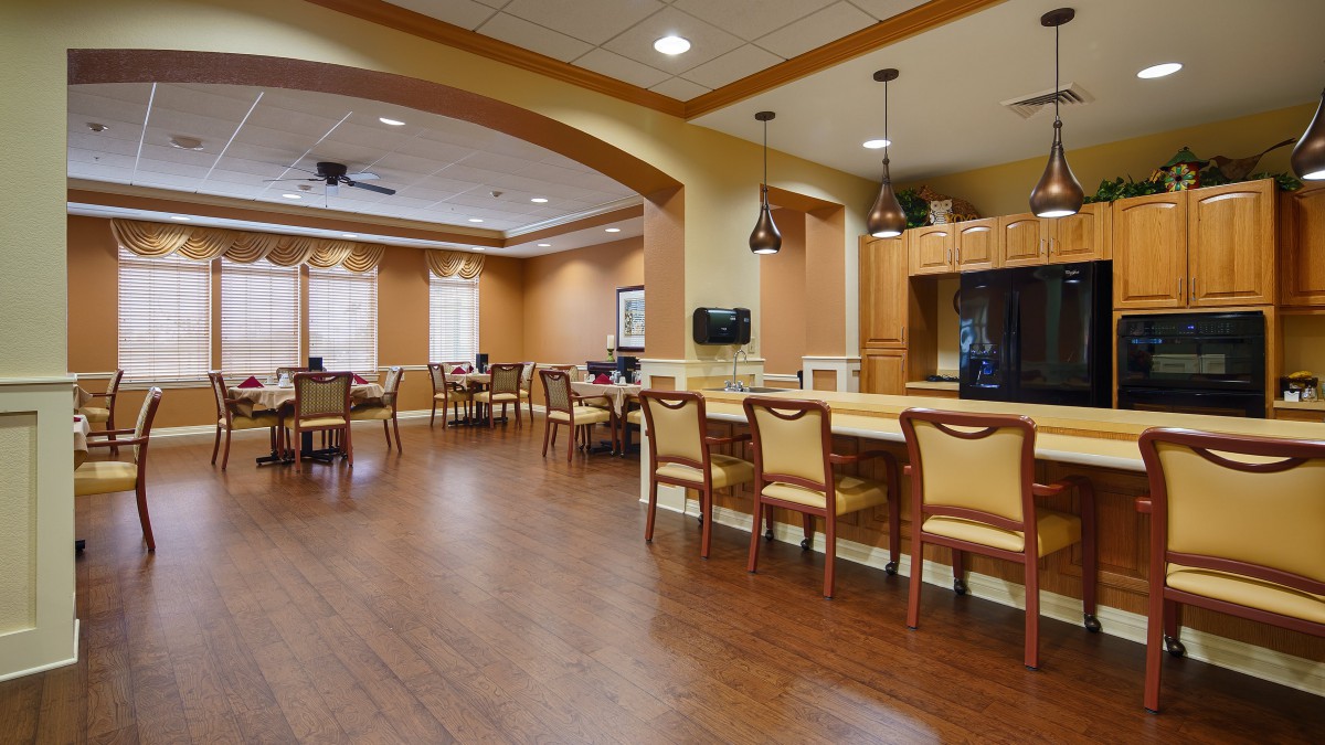 A cozy dining area with wooden flooring and elegant furniture.