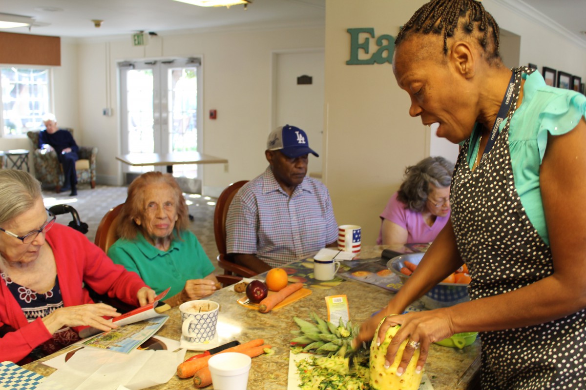 A group of people in a community kitchen participating in a cooking activity.