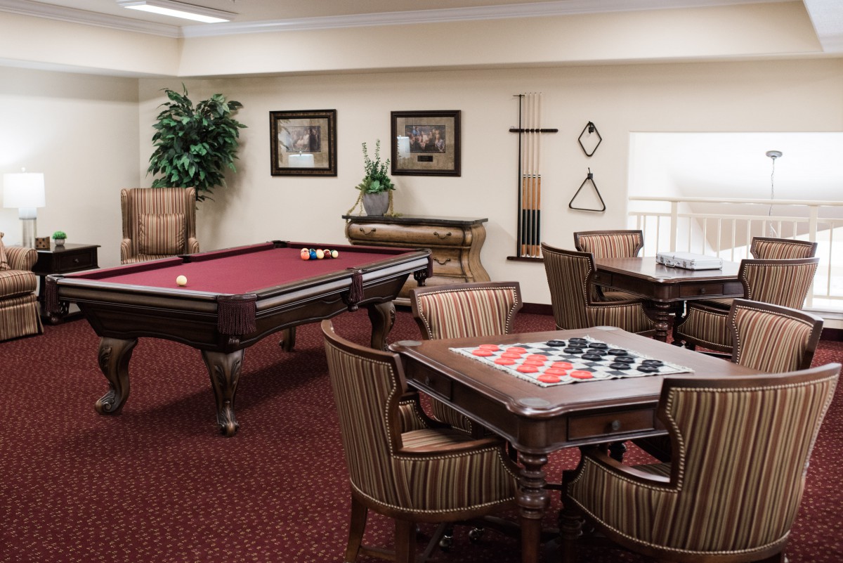 A cozy game room featuring a pool table and checkers set.