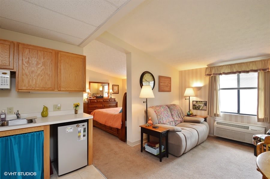 A cozy living space featuring a combined living room and bedroom area with comfortable furnishings.