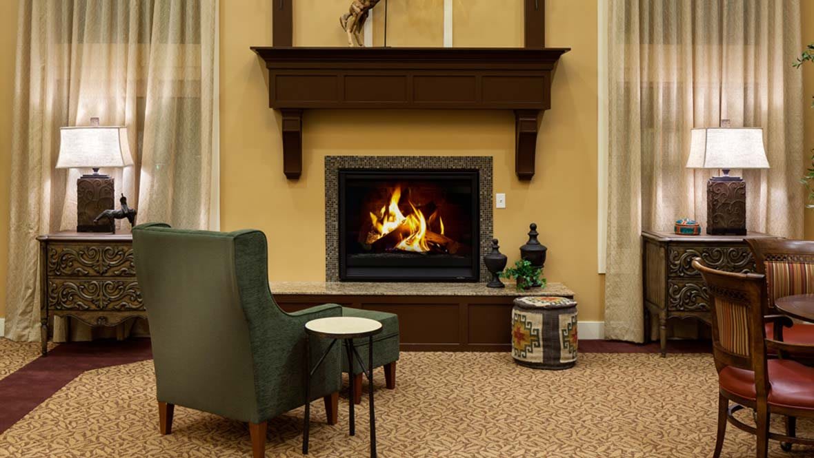 A cozy living room with a fireplace and comfortable seating.